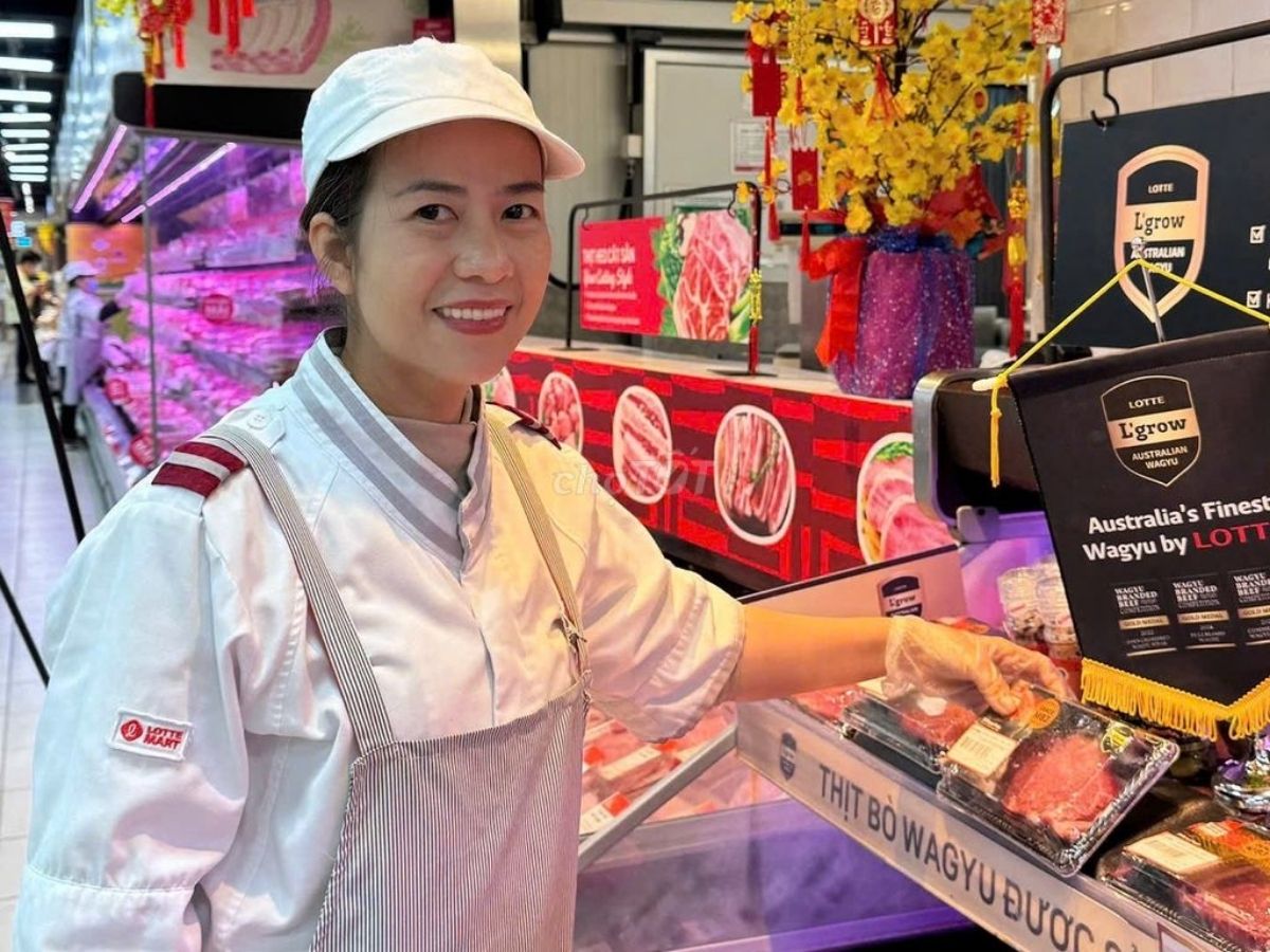 Nhân viên Lotte Mart ở quầy thực phẩm tươi sống đang đeo tạp dề và mũ gọn gàng